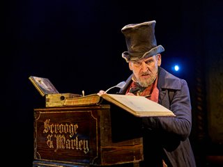 Christopher Eccleston as Ebenezer Scrooge in A Christmas Carol at The Old Vic (2023), photo by Manuel Harlan (1).jpg